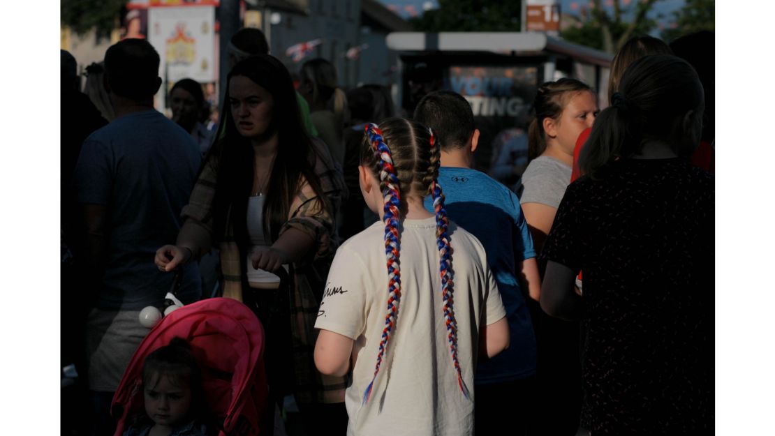 A young loyalist sporting red, white, and blue braids  -- the colors of the Union Flag -- attends a parade on the Shankill Road in west Belfast.  