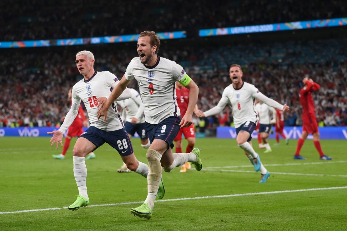 Harry Kane of England is congratulated by Phil Foden after scoring the second goal against Denmark.