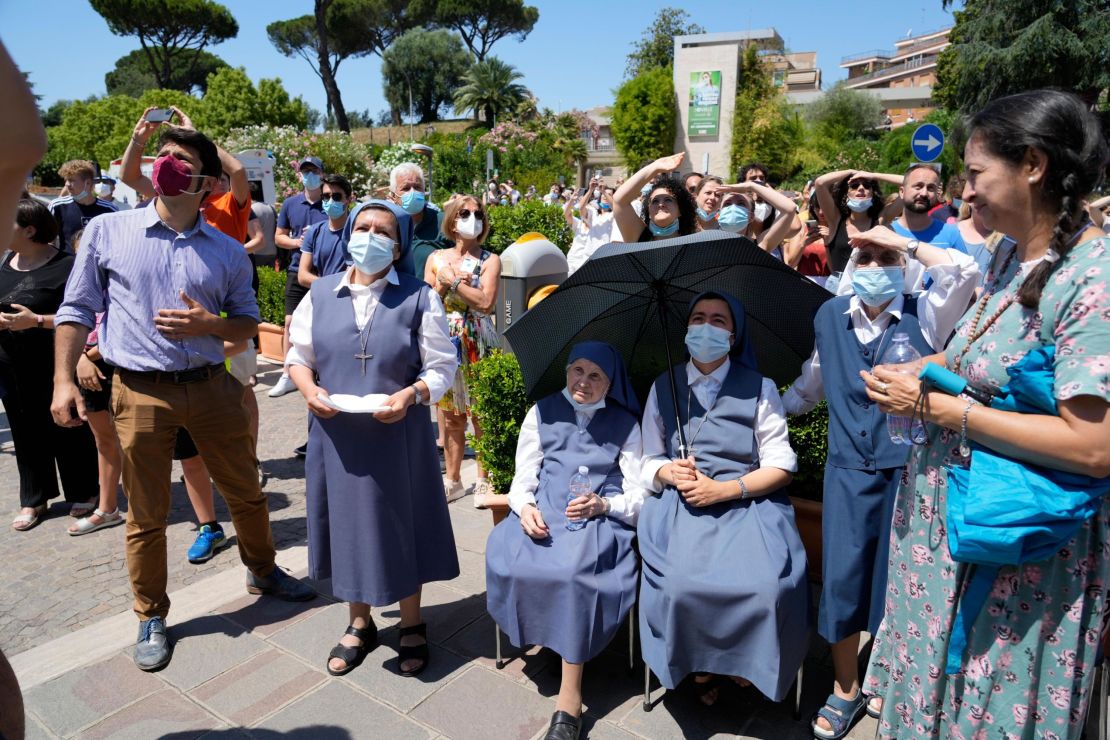 An audience listens to Pope Francis deliver his prayer from a hospital balcony on Sunday.