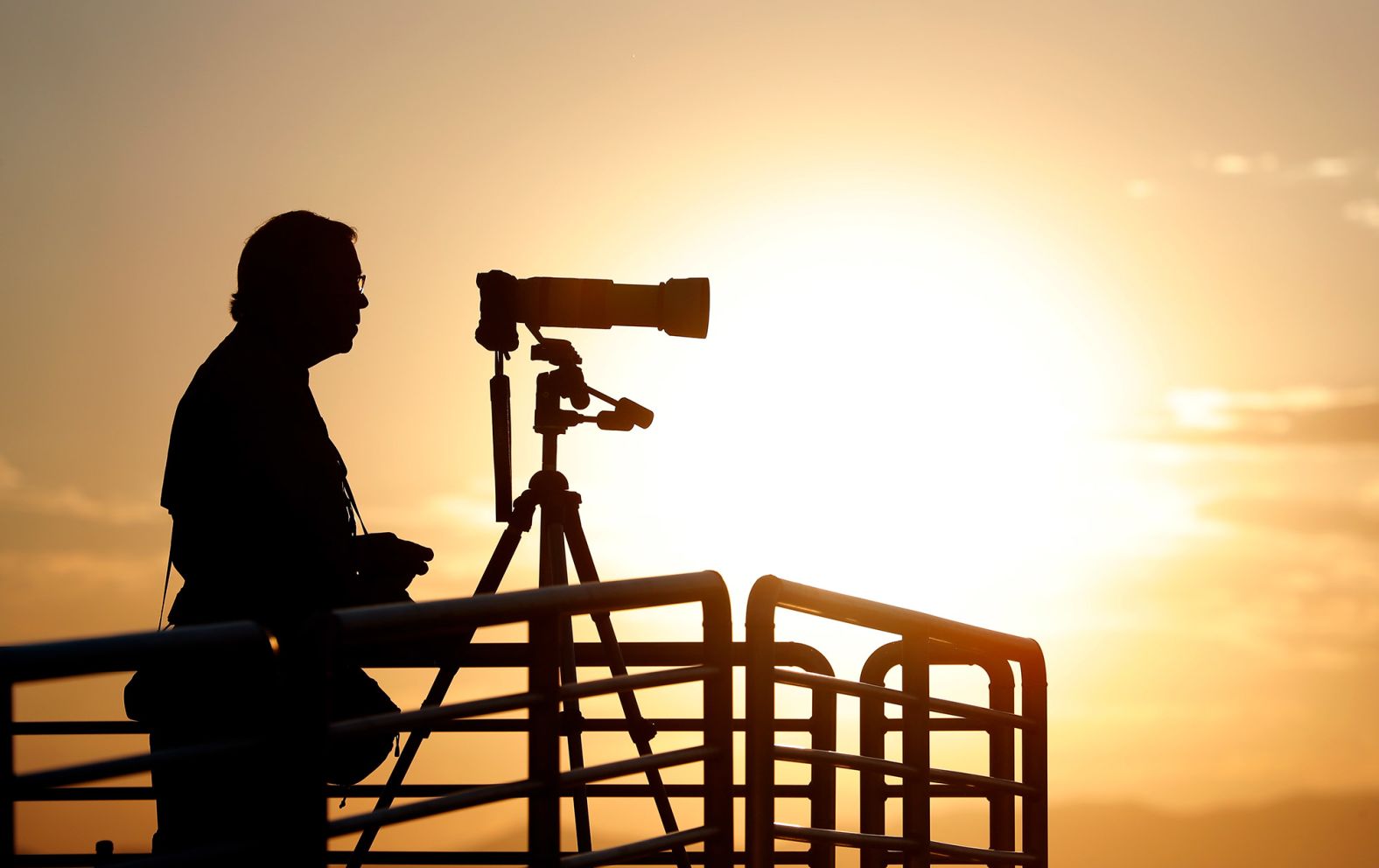 A photographer prepares his camera as the sun rises over Spaceport America.