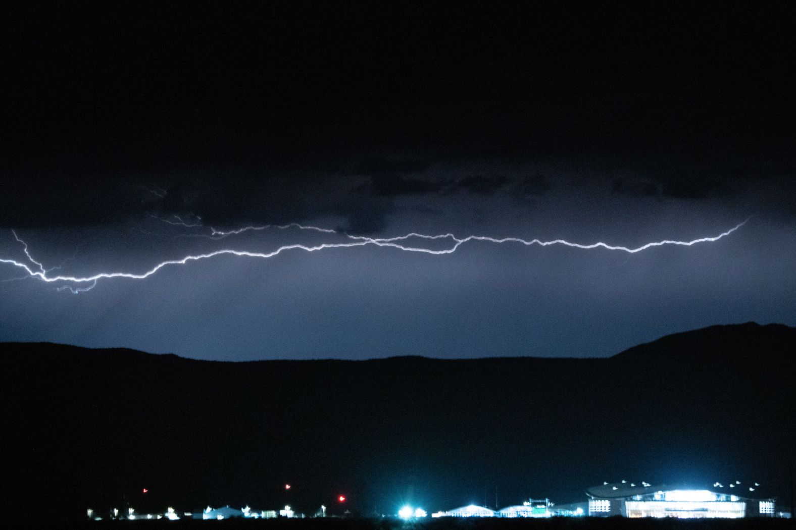 Lightning flashes over Spaceport America on Saturday, July 10. Virgin Galactic's livestream of the launch was delayed 90 minutes from its originally scheduled time thanks to high winds the night before.