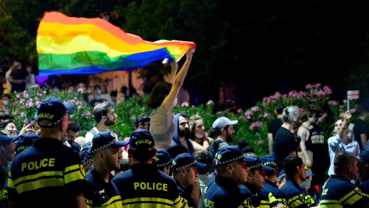 A demonstrator holds a rainbow flag at a rally in Tbilisi, Georgia, on July 6, in support of people who were injured when members of violent groups disrupted a Pride march the day before.