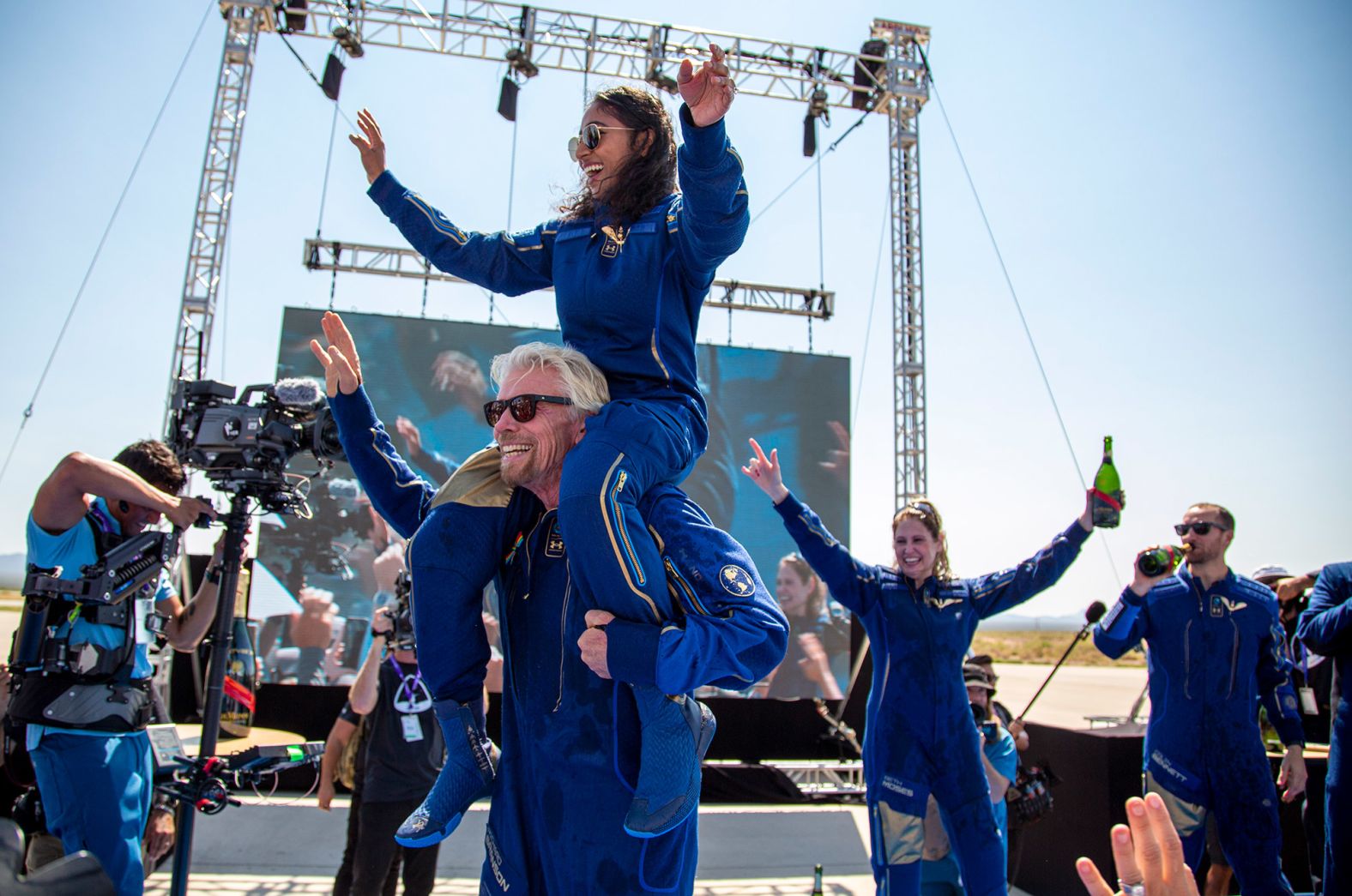 Branson carries crew member Sirisha Bandla on his shoulders while celebrating after landing back on Earth. Bandla is the second woman born in India to fly to space.