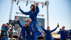 Virgin Galactic founder Richard Branson carries crew member Sirisha Bandla on his shoulders while celebrating their flight to space at Spaceport America near Truth or Consequences, New Mexico, Sunday, July 11, 2021. (AP Photo/Andres Leighton)