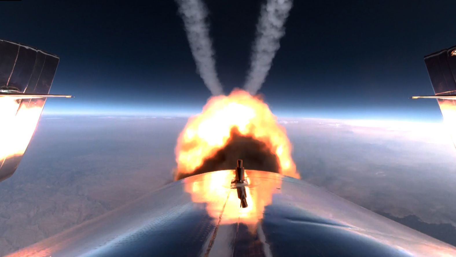The VSS Unity's rocket burns during the flight.