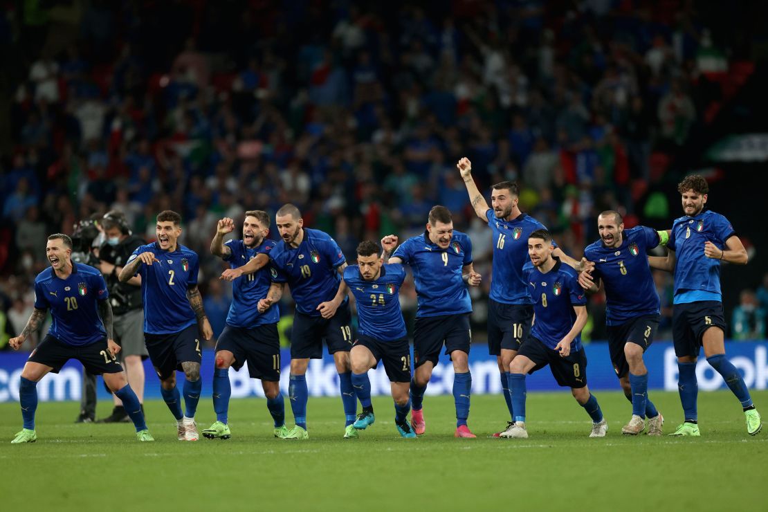 Italy players celebrate winning the penalty shootout against England. 