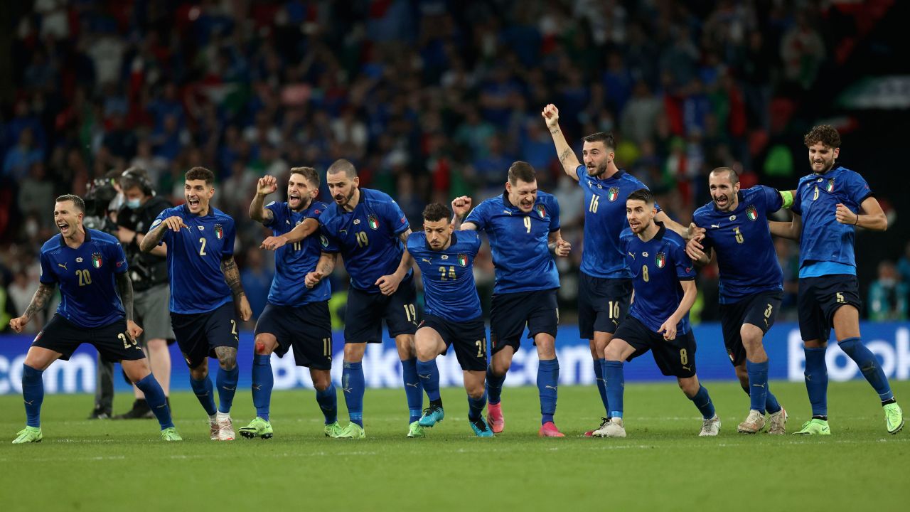 Italy players celebrate winning the penalty shootout against England. 