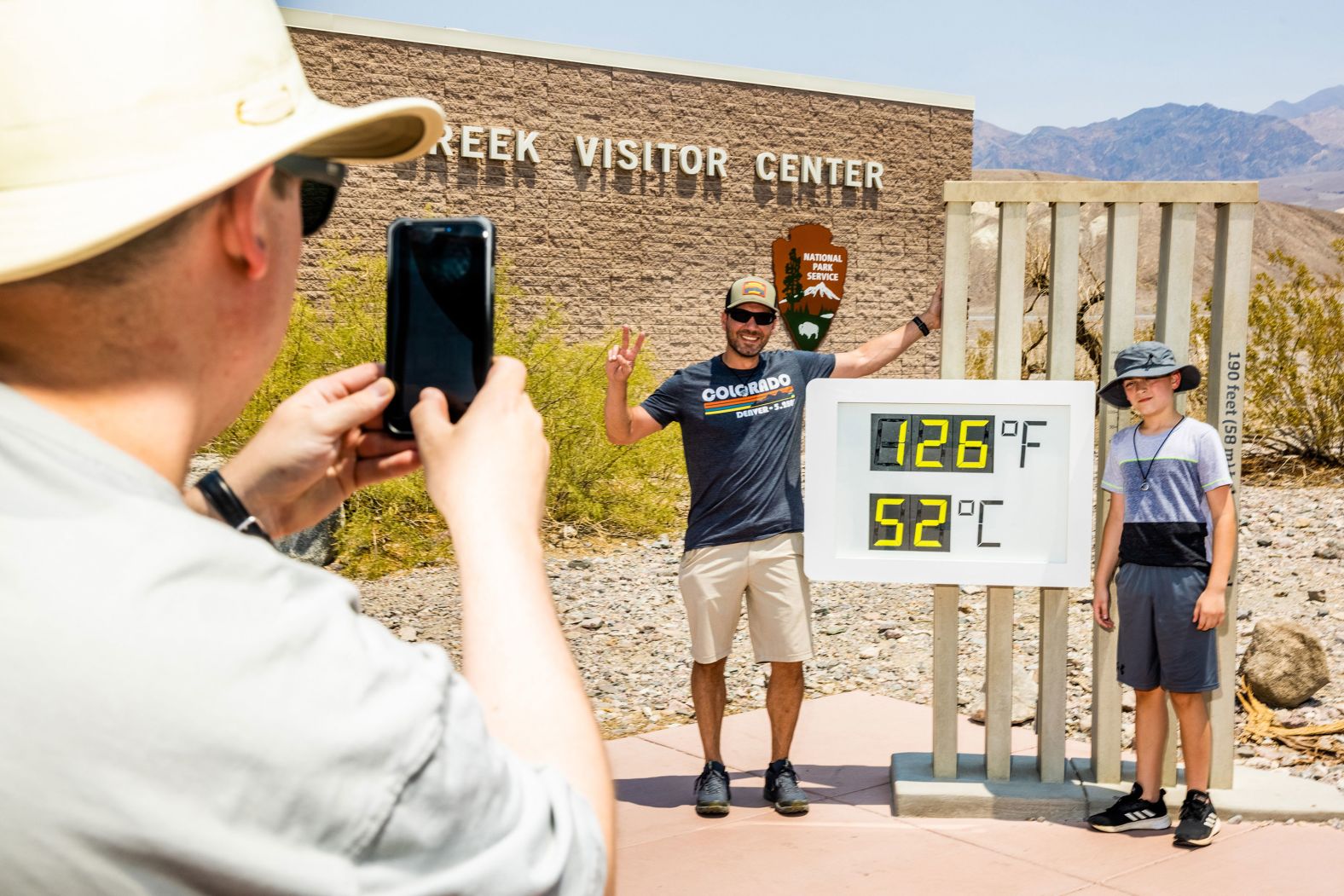 Visitors take photos in front of a thermometer in July 2021, at Death Valley National Park in Death Valley, California. Death Valley is known to be a hot place, but on July 9 <a href="https://www.cnn.com/2021/07/11/weather/weather-death-valley-heat-record-california-weekend/index.html" target="_blank">it hit 130 degrees Fahrenheit</a> for only the fifth time in recorded history.