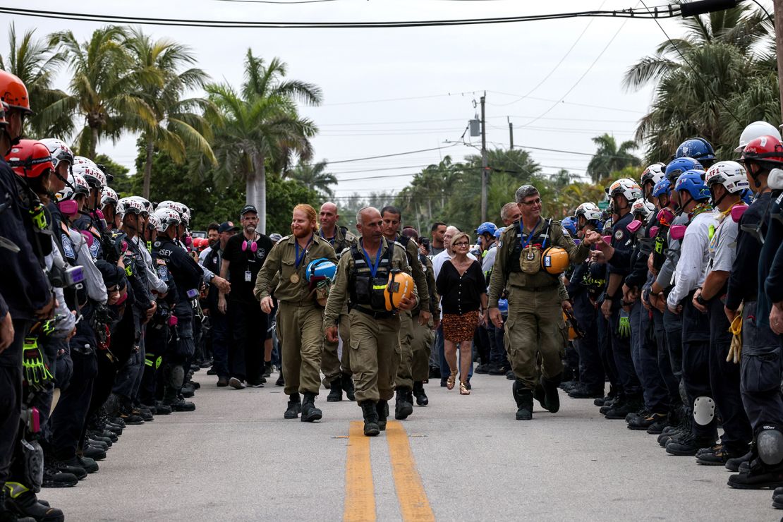 Members of Israel's National Rescue Unit are given a send-off by search and rescue personnel on July 10 in Surfside, Florida. 