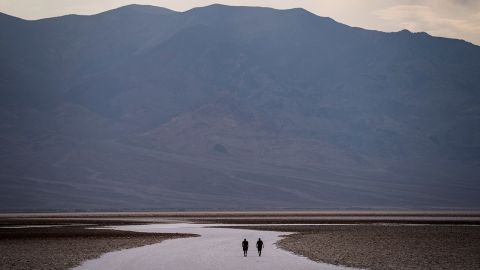 People walk on salt flats in California's Badwater Basin on Sunday.
