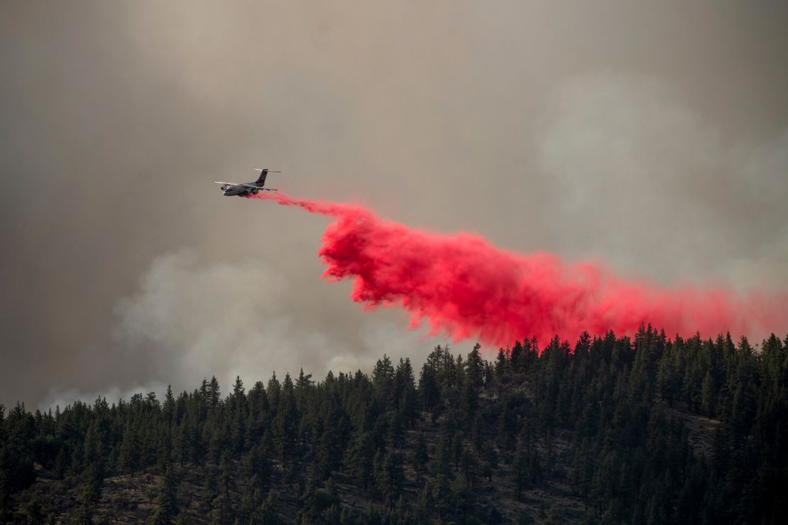 An air tanker drops retardant to keep the Sugar Fire, part of the Beckwourth Complex Fire, from reaching the Beckwourth community of unincorporated Plumas County, California, on Friday, July 9, 2021.