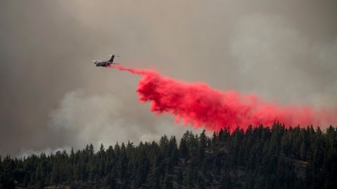 An air tanker drops retardant Friday to keep the Sugar Fire, part of the Beckwourth Complex Fire, from reaching the Beckwourth community in Plumas County, California.
