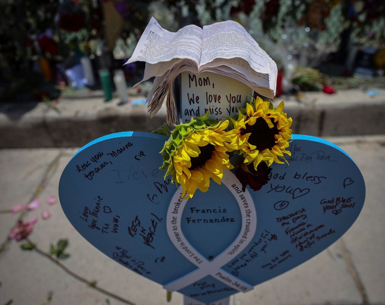 Wooden hearts with victims' names have been put up at the memorial site near the building's remains.