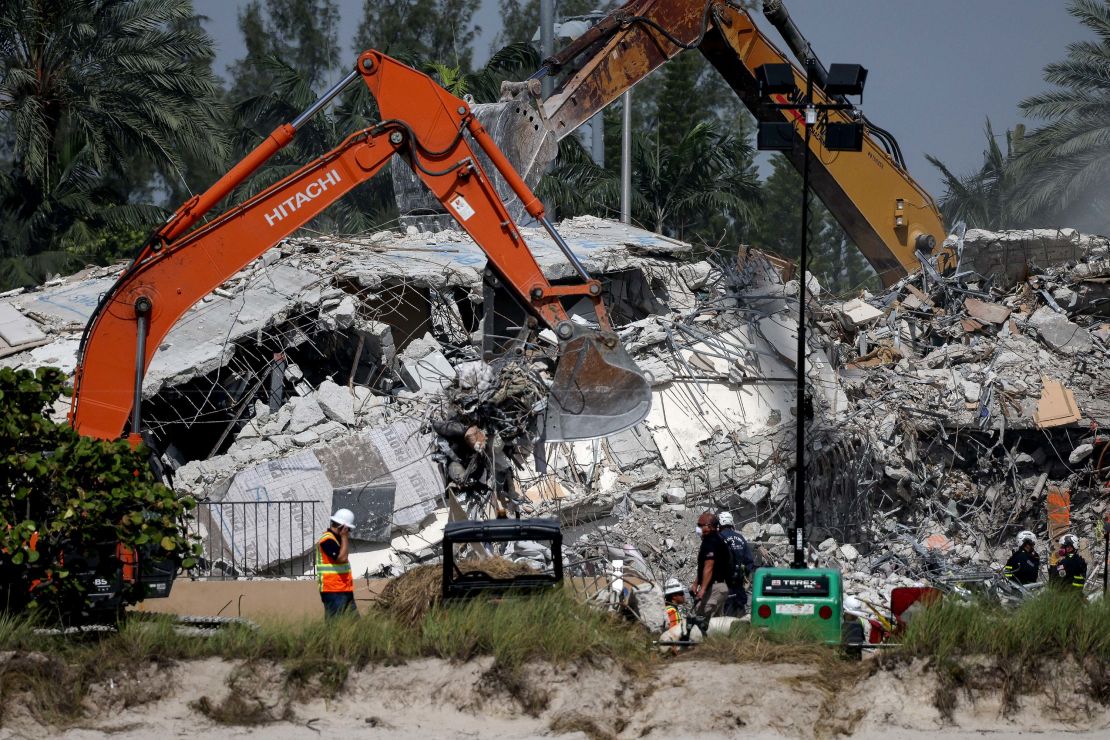 Excavators dig through the remains from the collapsed Champlain Towers South condo building.