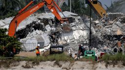SURFSIDE, FLORIDA - JULY 09: Excavators dig through the remains from the collapsed 12-story Champlain Towers South condo building on July 09, 2021 in Surfside, Florida. With the death toll currently at 64 and 76 people still missing, search and rescue personnel continue their efforts. (Photo by Anna Moneymaker/Getty Images)