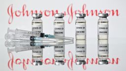An illustration picture shows vials with Covid-19 Vaccine stickers attached and syringes with the logo of US pharmaceutical company Johnson & Johnson on November 17, 2020. (Photo by JUSTIN TALLIS / AFP) (Photo by JUSTIN TALLIS/AFP via Getty Images)