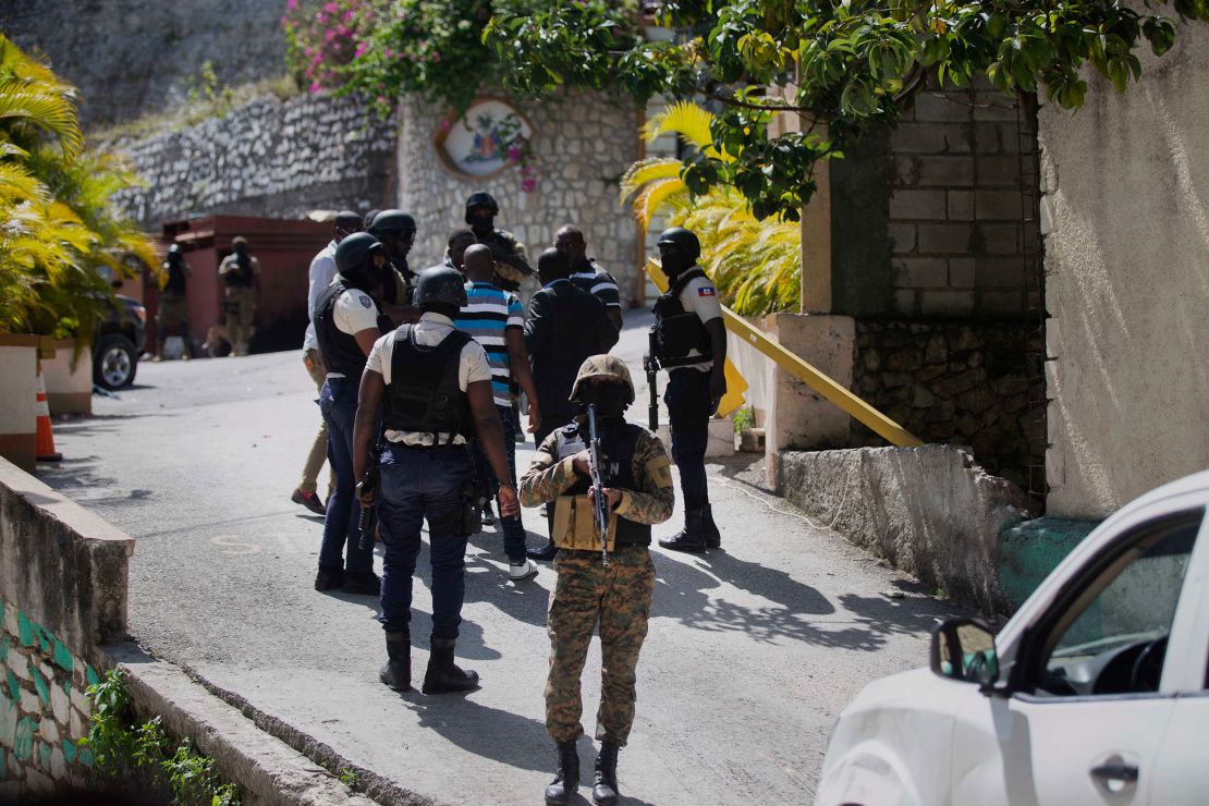 Security forces conduct an investigation as a soldier stands guard at the entrance to the residence of Haitian President Jovenel Moise, in Port-au-Prince, Haiti, Wednesday, July 7, 2021. 