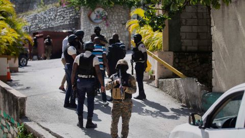 Security forces conduct an investigation as a soldier stands guard at the entrance to the residence of Haitian President Jovenel Moise, in Port-au-Prince, Haiti, Wednesday, July 7, 2021.
