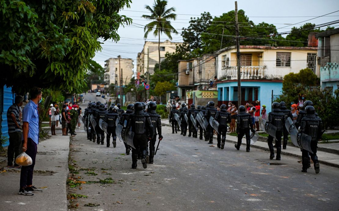 Riot police walk the streets after a demonstration against the government of Cuban President Miguel Diaz-Canel in Arroyo Naranjo Municipality, Havana on July 12.
