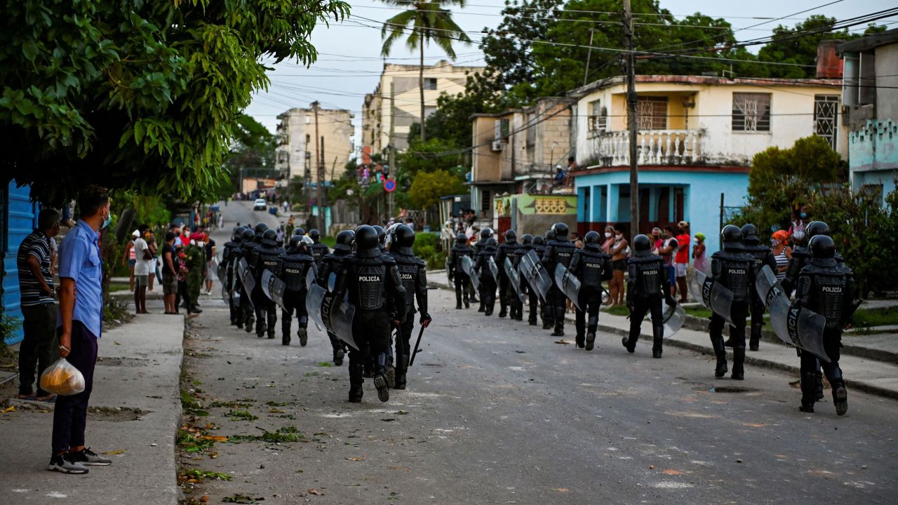 Riot police walk the streets after a demonstration against the government of Cuban President Miguel Diaz-Canel in Arroyo Naranjo Municipality, Havana on July 12.
