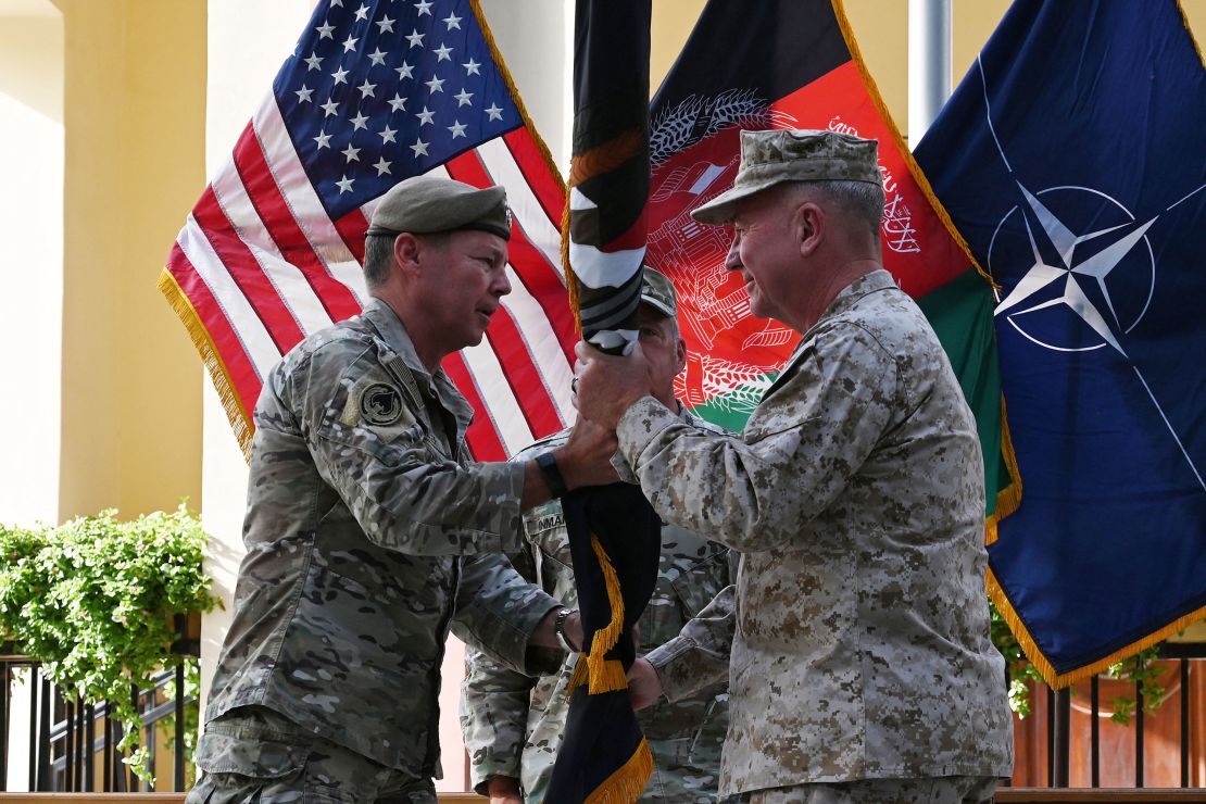 General Austin Miller, the top US commander in Afghanistan, passes the flag of US-led Resolute Support mission to General Kenneth McKenzie, the head of US Central Command, on July 12.
