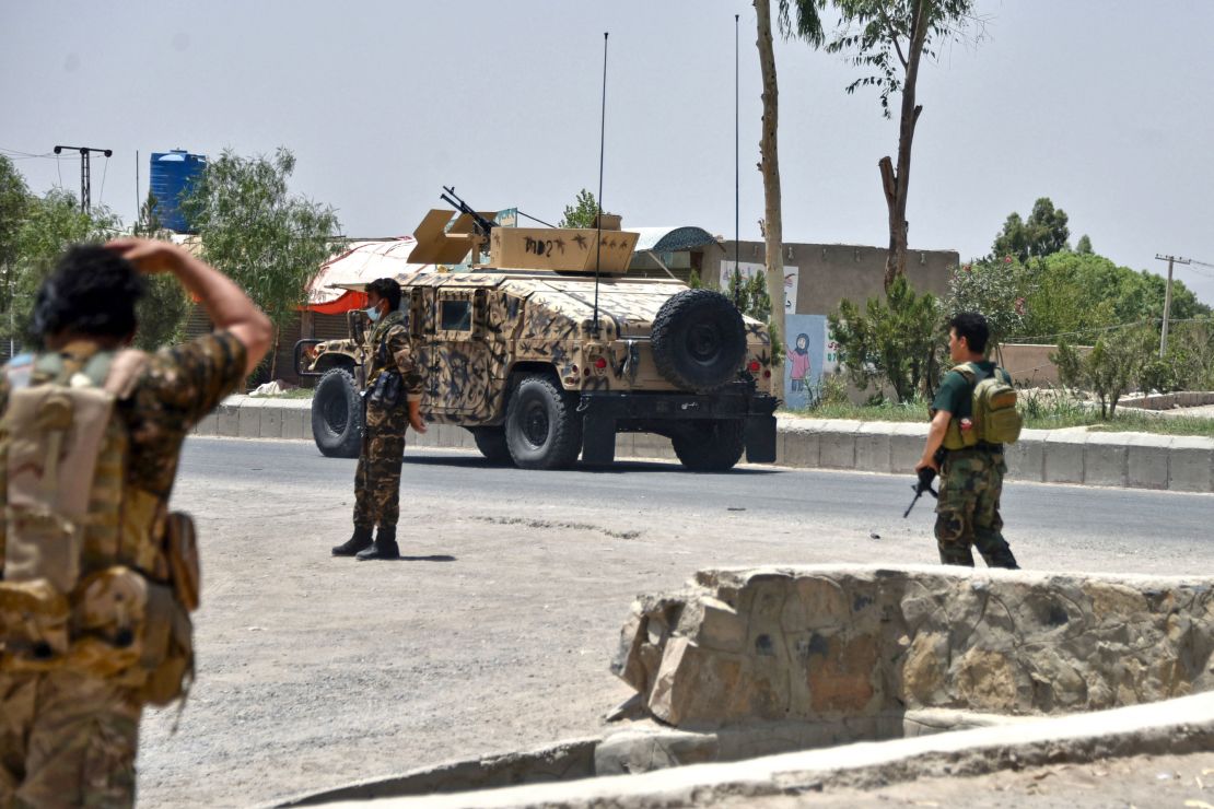 Afghan security personnel stand guard as Afghan security forces fight the Taliban in Kandahar on July 9.