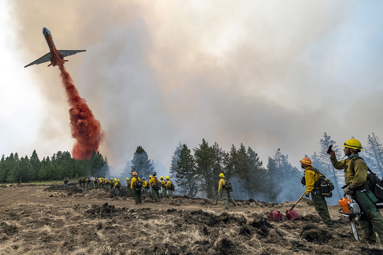 A plane drops fire retardant on Harlow Ridge above the Lick Creek Fire, southwest of Asotin, Washington, on July 12. The fire started the week before and has burned more than 50,000 acres of land between Asotin County and Garfield County.