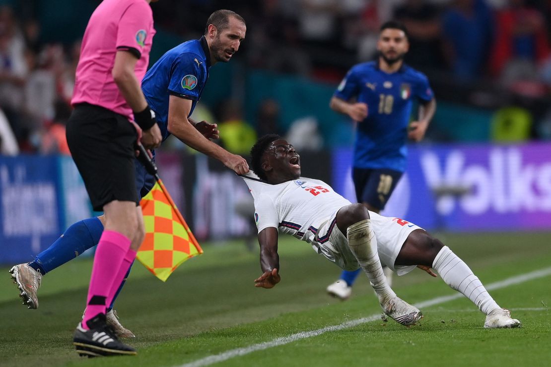 Giorgio Chiellini drags Bukayo Saka after being turned by the England forward.