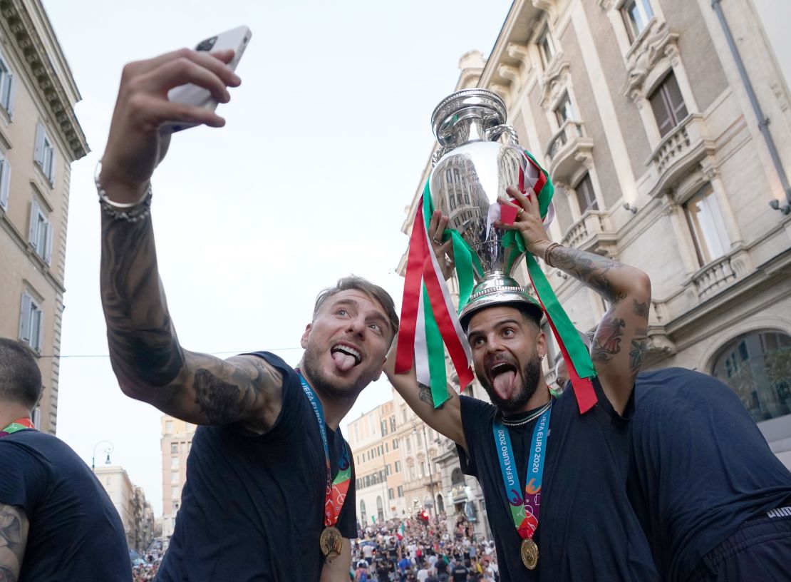 Ciro Immobile and Lorenzo Insigne celebrate with the Euro 2020 trophy.