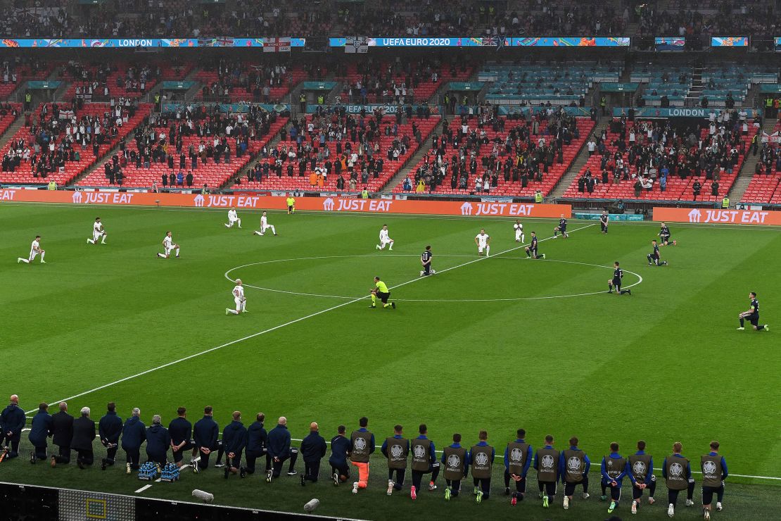 Players kneel before the UEFA Euro 2020 Group D football match between England and Scotland at Wembley Stadium in London.
