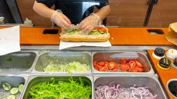 A worker at a Subway sandwich shop makes a tuna sandwich on June 22, 2021 in San Anselmo, California. 