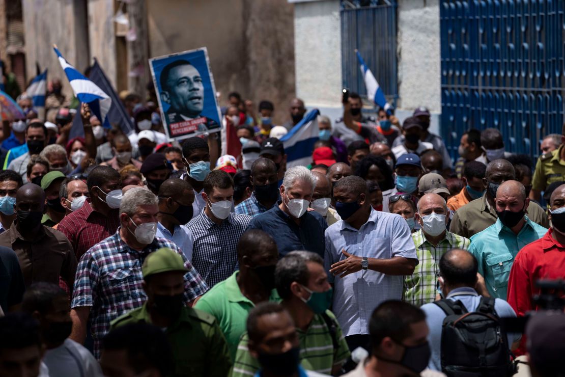 President Miguel Diaz-Canel (in dark blue shirt, wearing a mask) walks with supporters Sunday after an anti-government protest in San Antonio de los Banos, Cuba.  