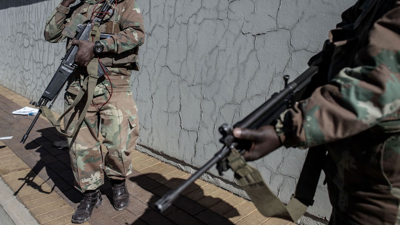 South Africa National Defence Force soldiers are deployed in Soweto to help police tackle deadly violence and looting.
