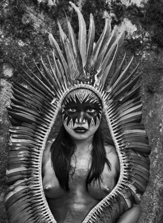 In the village of Mutum, Rio Gregório Indigenous Territory, Bela Yawanawá poses for Salgado with headdress and painted face. The Yawanawá people underwent a cultural revival in the 1990s that restored the teaching of the traditional language and the tribe's oral history and mythology, writes the photographer. 
