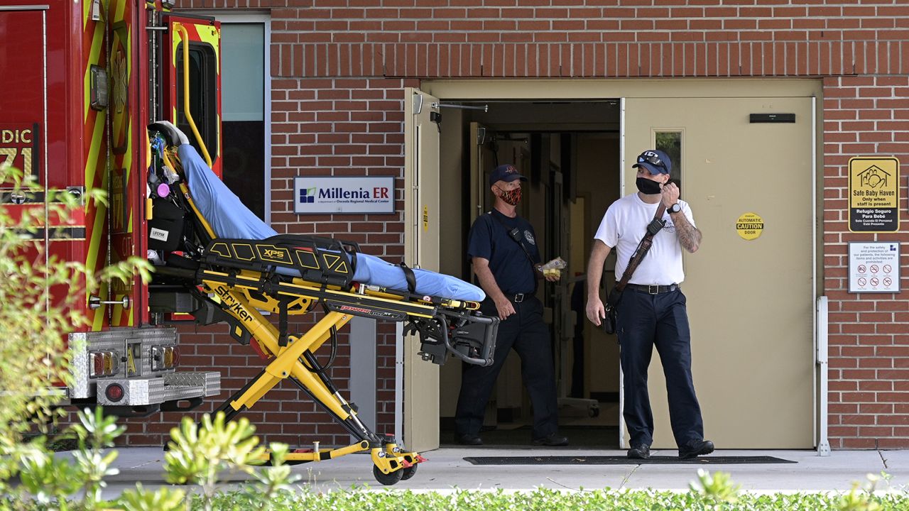 Emergency personnel wear face masks to help prevent the spread of COVID-19 while leaving an hospital clinic emergency room during a new coronavirus pandemic, Wednesday, March 24, 2021, in Orlando, Fla. (Phelan M. Ebenhack via AP)