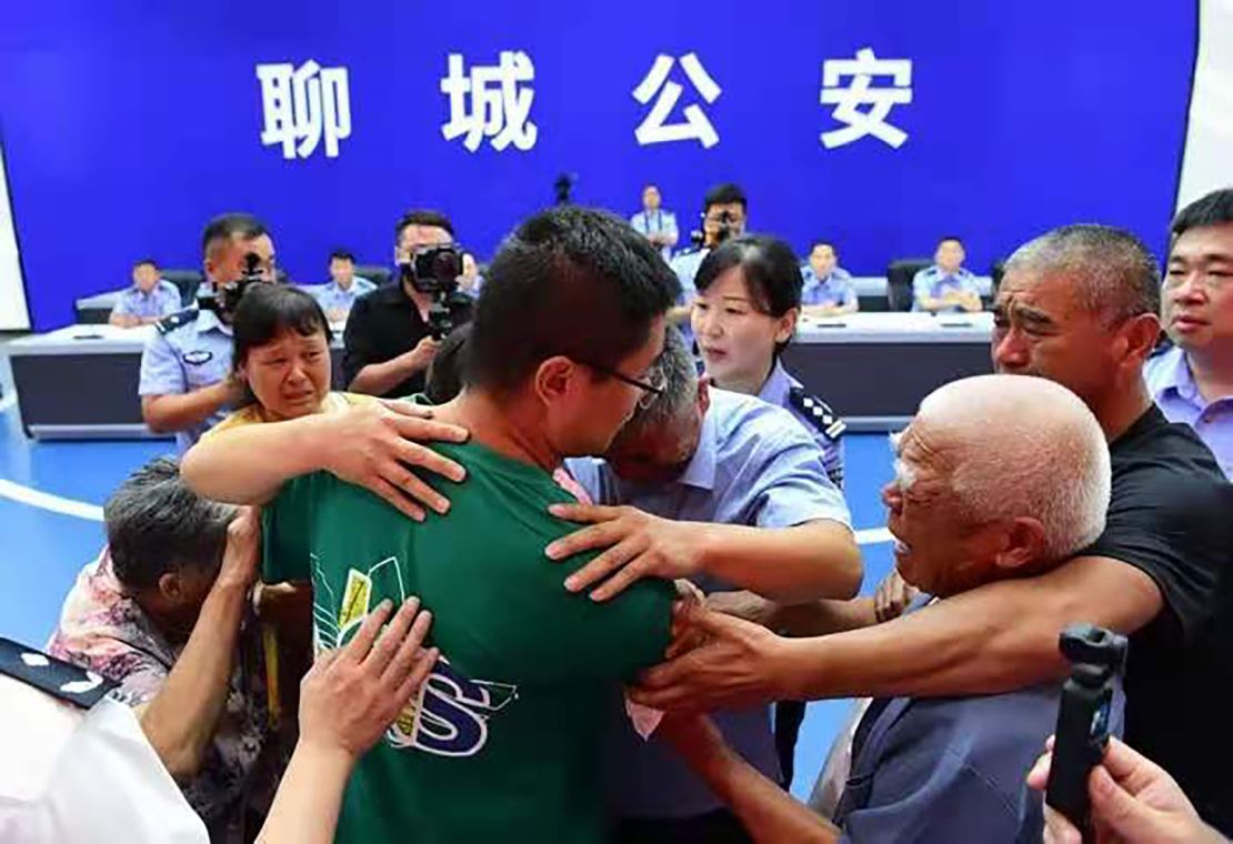 Guo Xinzhen (center) embraces his family at a reunion in Liaocheng, China, on July 11.