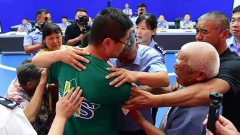 Guo Xinzhen (center) embraces his family at a reunion in Liaocheng, China, on July 11.