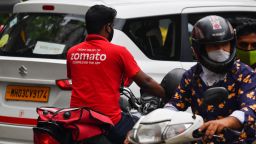 A deliveryman working for Zomato, an online food delivery application, rides a motorbike along a street in Mumbai on July 8, 2021. - Indian food delivery giant Zomato announced plans on July 8 to raise 93.75 billion rupees ($1.3 billion) via an initial public offering, the latest firm to take advantage of a strong rally in local equities. (Photo by INDRANIL MUKHERJEE / AFP) (Photo by INDRANIL MUKHERJEE/AFP via Getty Images)