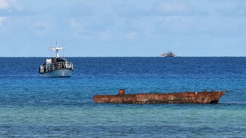A research boat (L) and Filipino fishing vessel (back R) anchored near Thitu island in the disputed Spratly islands on April 21, 2017.