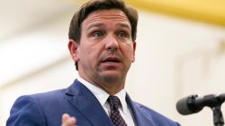 Florida Gov. Ron DeSantis, center, speaks during a news conference at West Miami Middle School in Miami on Tuesday, May 4, 2021.