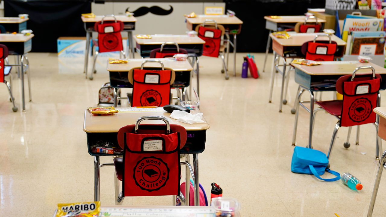 FILE - In this Thursday, March 11, 2021 file photo, desks are arranged in a classroom at an elementary school in Nesquehoning, Pa. In the fall of 2021, vaccinated teachers and students should no longer wear masks inside school buildings and no one need bother with them outside, the Centers for Disease Control and Prevention said Friday, July 9, 2021, in relaxing its COVID-19 guidelines. (AP Photo/Matt Slocum, File)