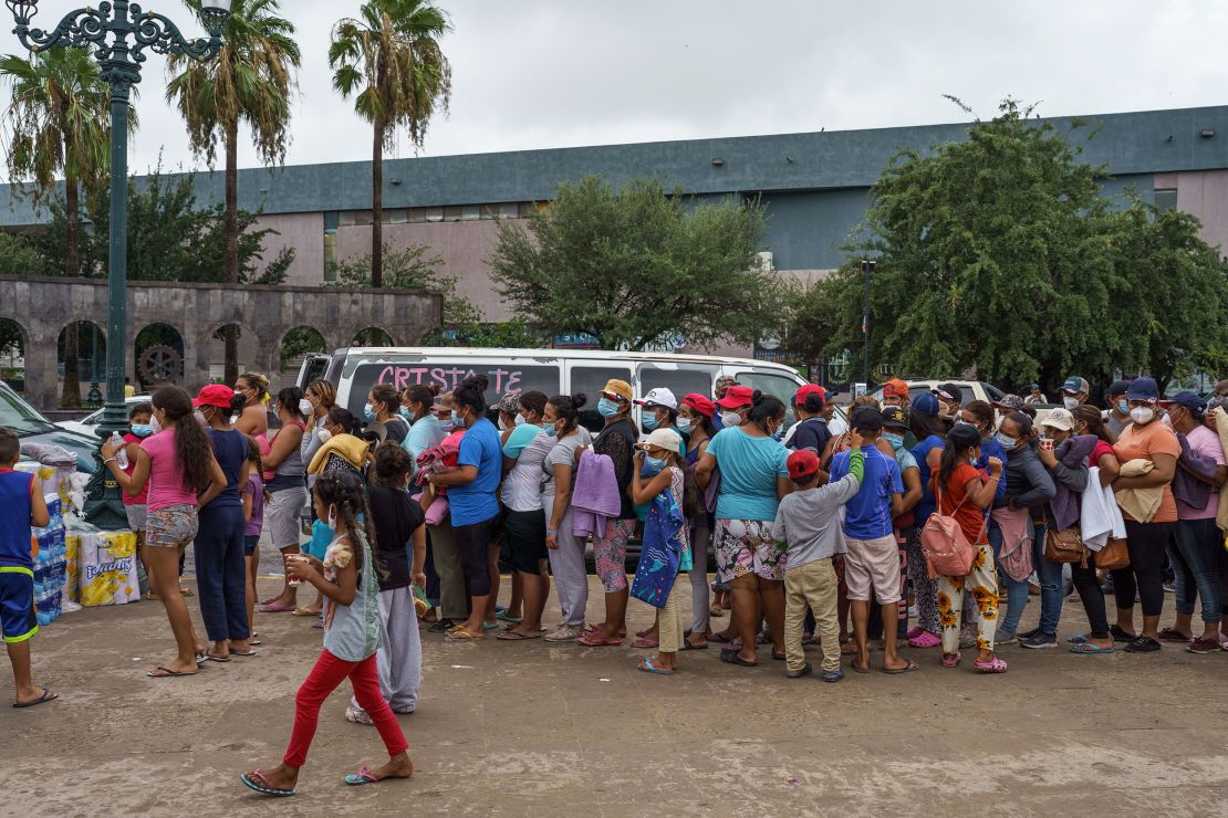 Migrants line up for food in a makeshift migrant camp in the border town of Reynosa, Tamaulipas, Mexico, on July 10, 2021. About 1,000 people from Central America and other Latin American countries are living in the camp, hoping for a chance to enter the United States.