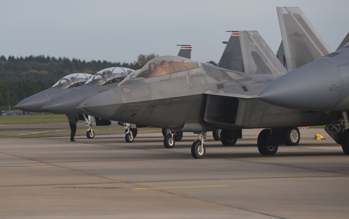 A US Air Force F-22 Raptor lines up next to three F-15E Strike Eagles at Royal Air Force Lakenheath, England, in 2017. 