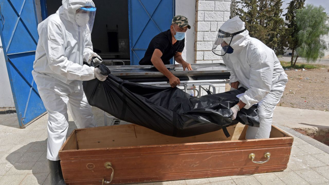 The body of a Covid-19 victim is placed into a casket at the Ibn al-Jazzar hospital in the Tunisian city of Kairouan on July 4, 2021. 