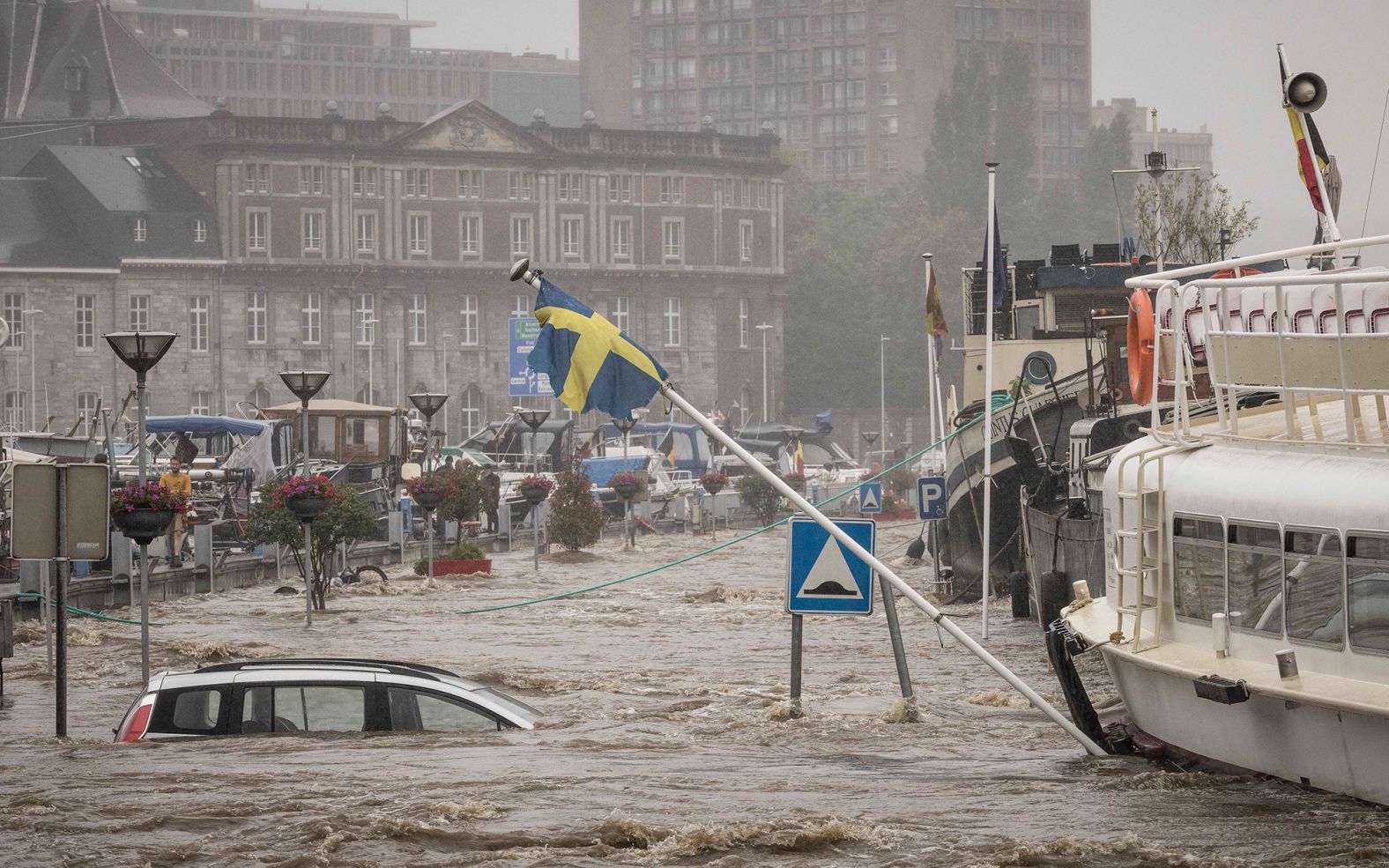 A car floats in the Meuse River during heavy flooding in Liege, Belgium, on Thursday.