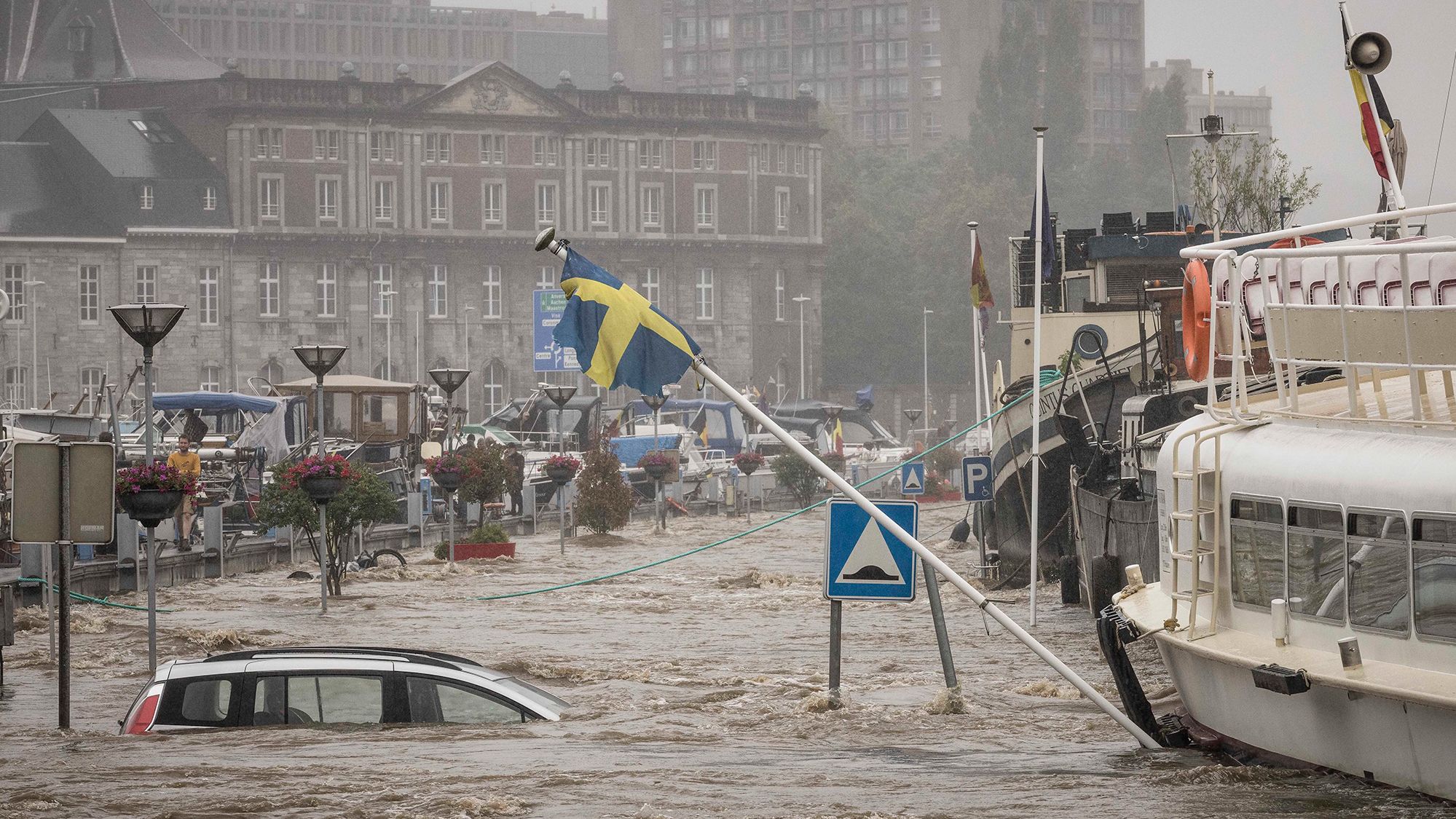 A car floats in the Meuse River during heavy flooding in Liege, Belgium, on Thursday.