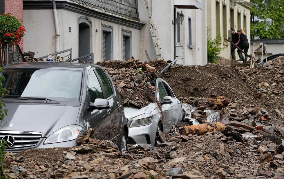 Cars are covered by debris in Hagen, Germany.