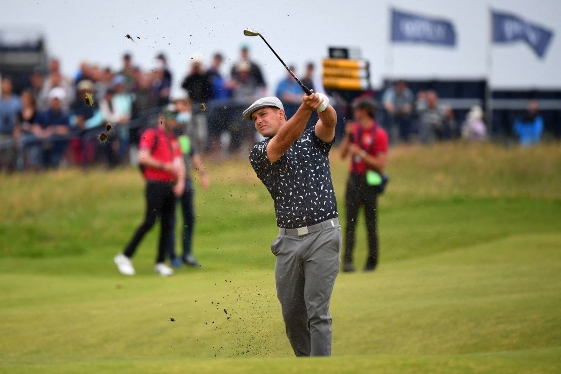 DeChambeau plays his approach shot from the 18th fairway during his first round of The Open.
