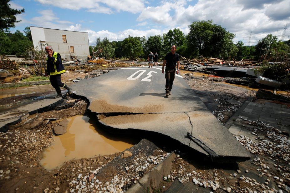People walk on a damaged road in Bad Neuenahr-Ahrweiler, Germany.