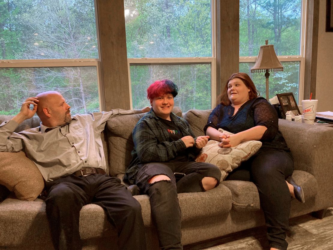In this April file photo, Andrew Bostad, center, talks with his mother, Brandi Evans, and stepdad, Jimmy Evans, at their home in Bauxite, Arkansas.